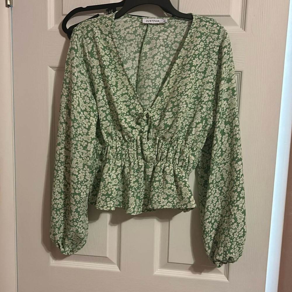Green with white flowers. Low cut. Cinched waist with flare out bottom.